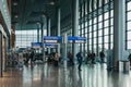 People walking past directional signs in the terminal of Luxembourg airport Royalty Free Stock Photo