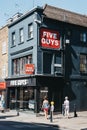 People walking past Five Guys restaurant in Richmond, London, UK Royalty Free Stock Photo