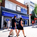 People Walking Past A High Street Branch Of The Nationwide Building Society