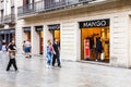 People walking past the Mango clothing store Royalty Free Stock Photo