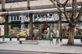 People walking past Planet Organic food store in Tottenham Court Road, London, UK