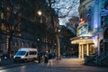 People walking past the Playhouse Theatre on Northumberland Avenue in the evening, London, UK