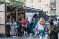 People walking past queue at Beijummy stall inside Spitalfields Market, London, UK Royalty Free Stock Photo