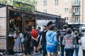 People walking past queue at Beijummy stall inside Spitalfields Market, London, UK Royalty Free Stock Photo