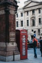 People walking past red phone box next to St. Pancras Renaissanc Royalty Free Stock Photo