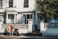 People walking past `For Sale ` sign on a house in Holland Park,LOndon, UK. Royalty Free Stock Photo