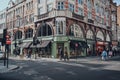 People walking past the shops and restaurants in Fitzrovia, London, UK