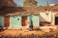 People walking past small traditional indian village house. Colorful buildings of rural area in India