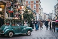 People walking past and taking photos of a car Christmas decorations in Covent Garden Market, London, UK