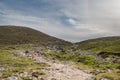 People walking on a path to the top of Croagh Patrick, Westport, county Mayo, Ireland. Blue cloudy sky. Pilgrimage and hiking. Royalty Free Stock Photo