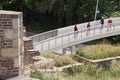 People walking on a pedestrian bridge that connects Kalemegdan fortress with promenade on river Sava in Belgrade, Serbia