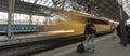 People walking on the platform preparing to board the arriving yellow Regiojet train. Royalty Free Stock Photo