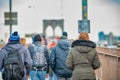 People walking on the promenade of the famous Brooklyn Bridge in winter season, back view. New York City, NY - USA Royalty Free Stock Photo