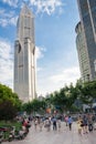 People walking on Puxi district with Tomorrow Square in the background. Tomorrow Square is the eighth-tallest building in Shanghai