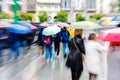 People walking in the rainy city with zoom effect Royalty Free Stock Photo