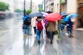People walking in the rainy city with zoom effect Royalty Free Stock Photo