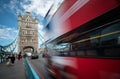 People walking and red traditional London bus crossing the famous London Tower bridge Royalty Free Stock Photo