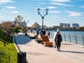 People walking on renovated embankment in Chelyabinsk city at sunny day