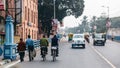 People walking, riding bicycle and cars running on the street in Kolkata, India. Royalty Free Stock Photo