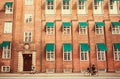 People walking and riding bicycles in city with brick houses in Copenhagen, Denmark Royalty Free Stock Photo