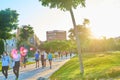 People walking and running with a mask at sunset through the River Park in the City of Arts and Sciences in Valencia Royalty Free Stock Photo