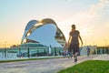 People walking and running with a mask at sunset through the River Park in the City of Arts and Sciences in Valencia Royalty Free Stock Photo