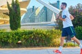 People walking and running with a mask at sunset through the River Park in the City of Arts and Sciences in Valencia Royalty Free Stock Photo