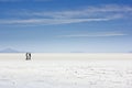 People walking on salt of salar de uyuni