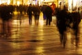 People walking in a shopping street in motion blur at night Royalty Free Stock Photo