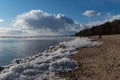 People walking on shore of Finland Gulf in early spring, Komarovo coast park , Russia Royalty Free Stock Photo