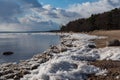 People walking on shore of Finland Gulf in early spring, Komarovo coast park , Russia Royalty Free Stock Photo
