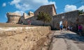 People walking in the small village along the fortified walls