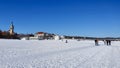 People are walking on a snow-covered beach in Sopot on a beautiful sunny day