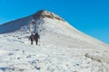 People walking on the snow in a mountain path