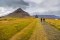 People walking on the south coast of the Snaefellsnes peninsula, Iceland
