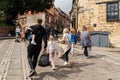 People walking Steep Hill, Lincoln, UK, a popular tourist attraction in the city.