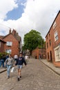 People walking Steep Hill, Lincoln, UK, a popular tourist attraction in the city.