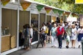 People walking and stopping to buy in a fair of crafts and typical products of Galicia in the park of the city center