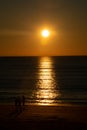 People walking at sunset on the beach of Cadiz capital, Andalusia. Spain. Royalty Free Stock Photo