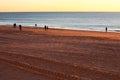 People walking at sunset on the beach of Cadiz capital, Andalusia. Spain. Royalty Free Stock Photo