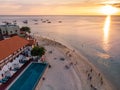 People Are walking on Sunset Beach. Zanzibar Aerial Shot of Stone Town Beach with Traditional Dhow Fisherman Boats in Royalty Free Stock Photo