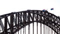 People walking on the Sydney Harbour Bridge with waving Australian flags Royalty Free Stock Photo