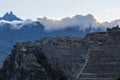 People walking on the terraces of Pumatallis, ancient Inca fortress and mountains covered in clouds, Sacred