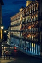 People walking on a Toledo street at night