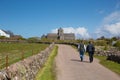 People walking towards Iona Abbey Scotland uk on the Scottish island off the Isle of Mull Scotland