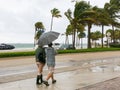 People walking in tropical storm, Fort Lauderdale, USA