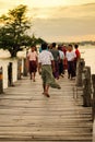 People walking in U bein bridge at sunset, is a crossing that spans the Taungthaman Lake near Amarapura in Myanmar Burma. Royalty Free Stock Photo