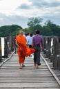 People walking in U bein bridge at sunset, is a crossing that spans the Taungthaman Lake near Amarapura in Myanmar Burma. Royalty Free Stock Photo