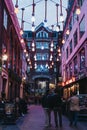 People walking under lightbulb lights in Carnaby Street, London, UK