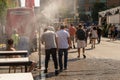 People walking under misting system to cool off during heatwave Royalty Free Stock Photo